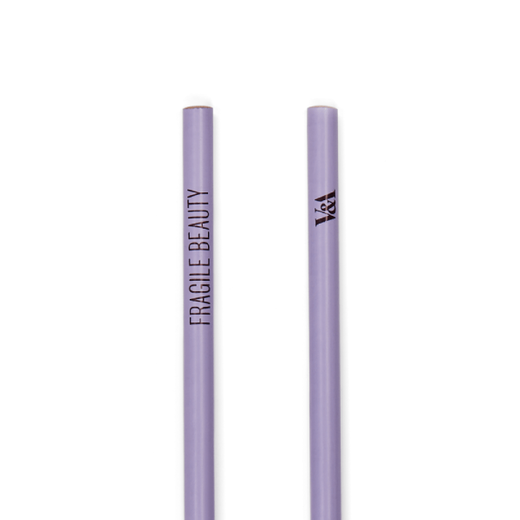A detail shot of two lilac pencils showing two sides of the same design. One pencil features the text Fragile Beauty in capital letters, the other carries the V&A logo.