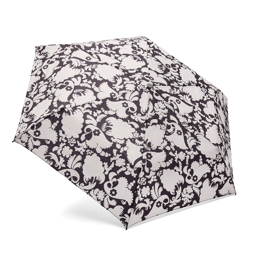 The top of an open umbrella with a black and white floral pattern.