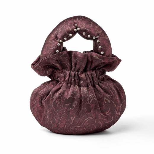 A pouch handbag made with a dark mauve vintage textile.