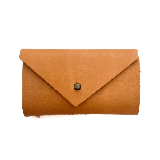 A needle case in ochre leather.