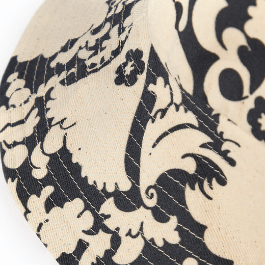 Detail of a bucket hat featuring a black and white Japanese floral pattern.
