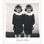 A book cover featuring a black and white photograph of two girls facing the camera.