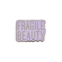 Lilac enamel pin badge featuring the text 'Fragile Beauty' in capital letters.