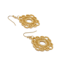 Two ornate hook earrings in gold tones.