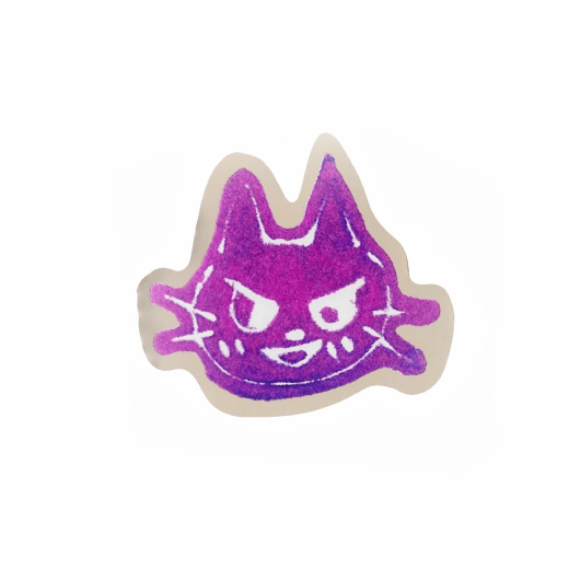 A purple sticker with metallic foil edges in the shape of a cat's face.