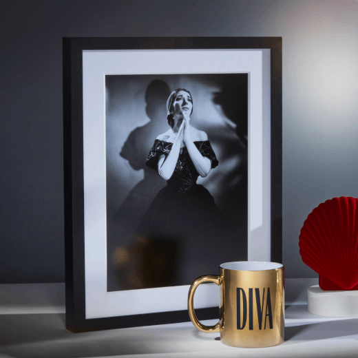 A framed black and white photograph of an opera singer.