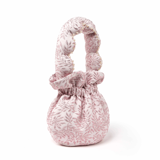 A round pouch handbag made with a floral pink vintage textile. The handle is decorated with white pearls.