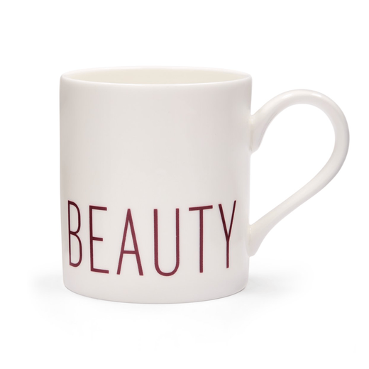 A white mug with the word "beauty" printed in purple capital letters on the bottom edge.