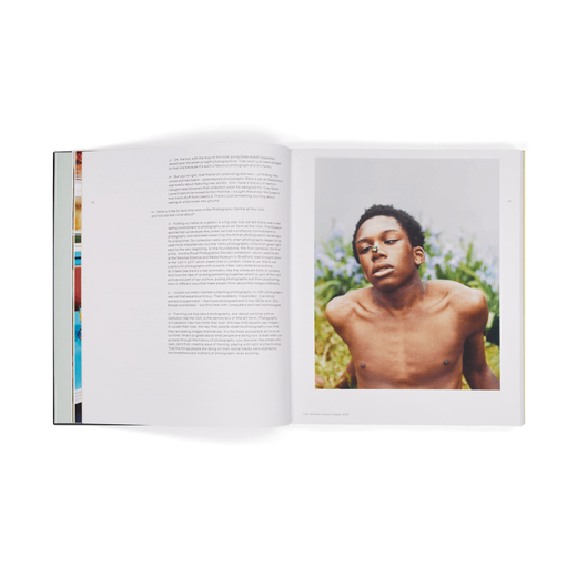 A book spread. On the left is a white page with black text; the right page shows the photograph of a black boy. A beetle is resting on his nose.