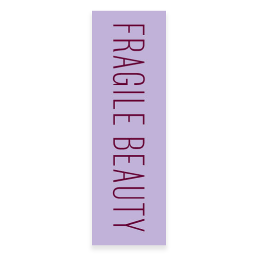 A lilac paper bookmark with the text Fragile Beauty in burgundy capital letters.