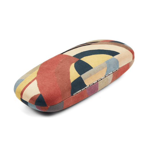 Glass case featuring an Art Deco fabric pattern in red, cream and blue.