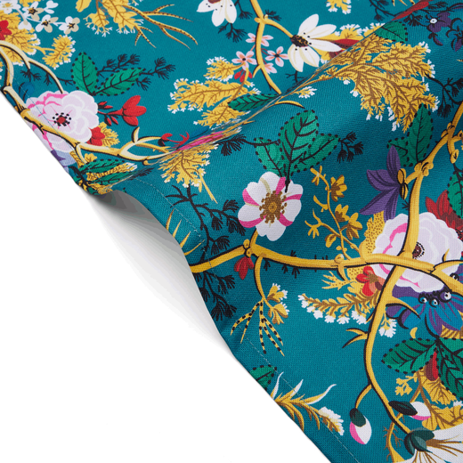 Detail of blue textile featuring a floral pattern.