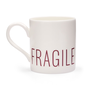 A white mug with the word "fragile" printed in purple capital letters on the bottom edge.