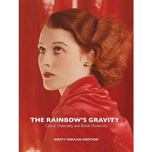 Book cover featuring a photographic portrait of a woman with red hair, wearing red clothes and posing in front of a red background.