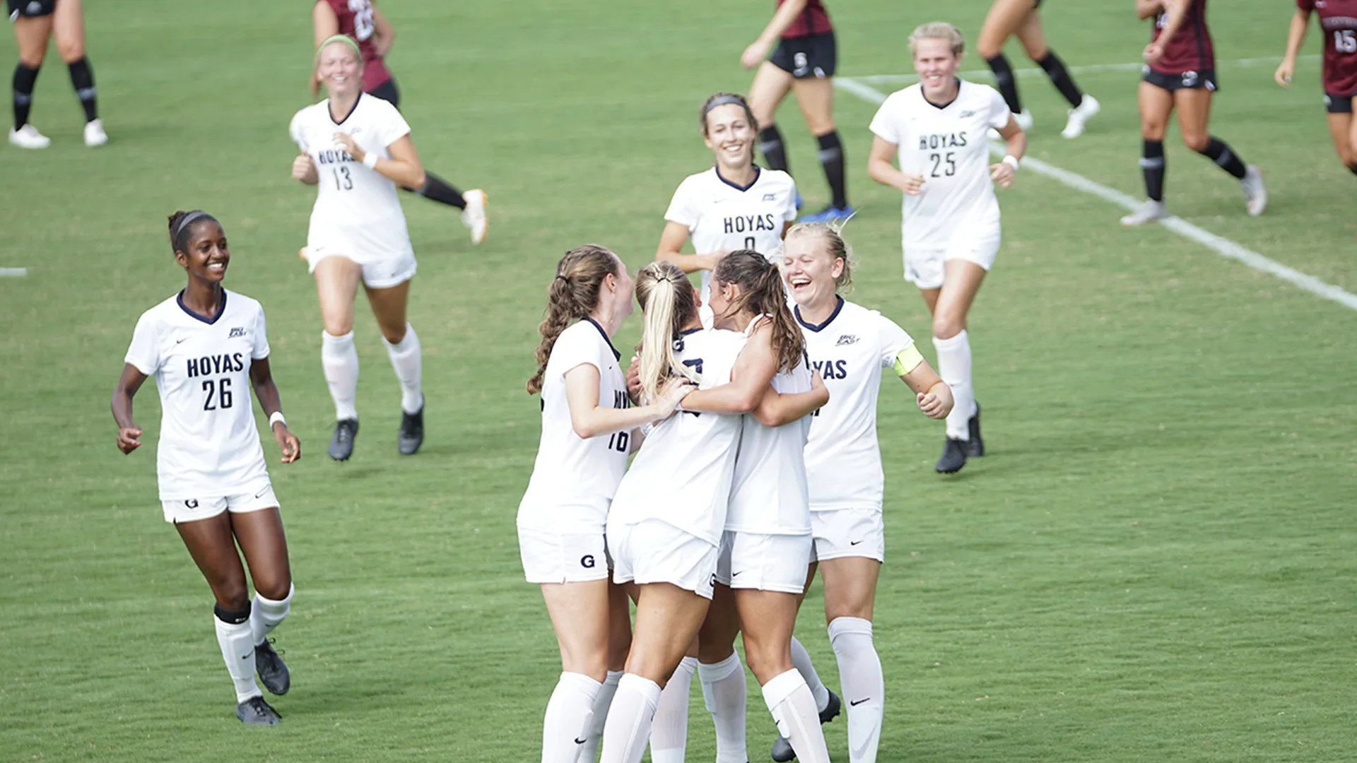 A women's football team celebrates during a match