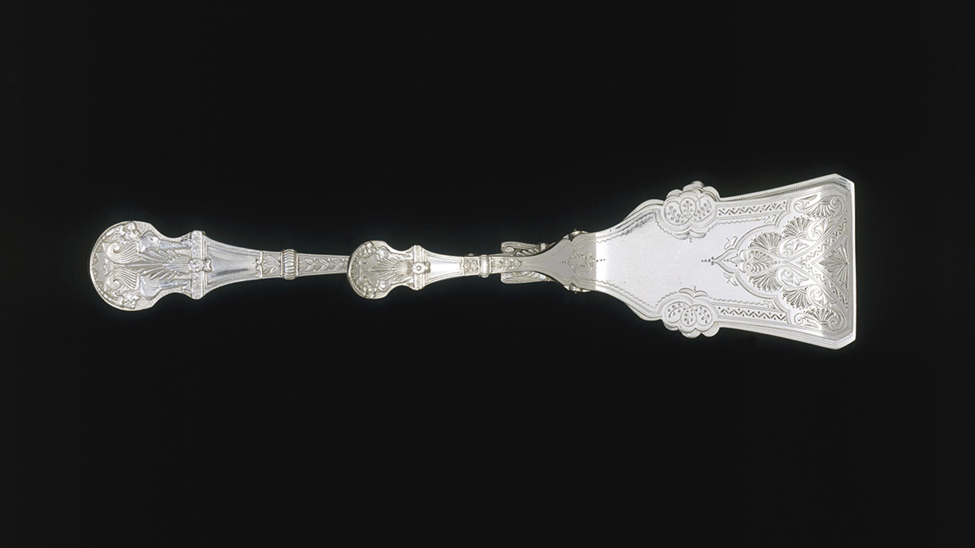 Silver serving tong with large flat end