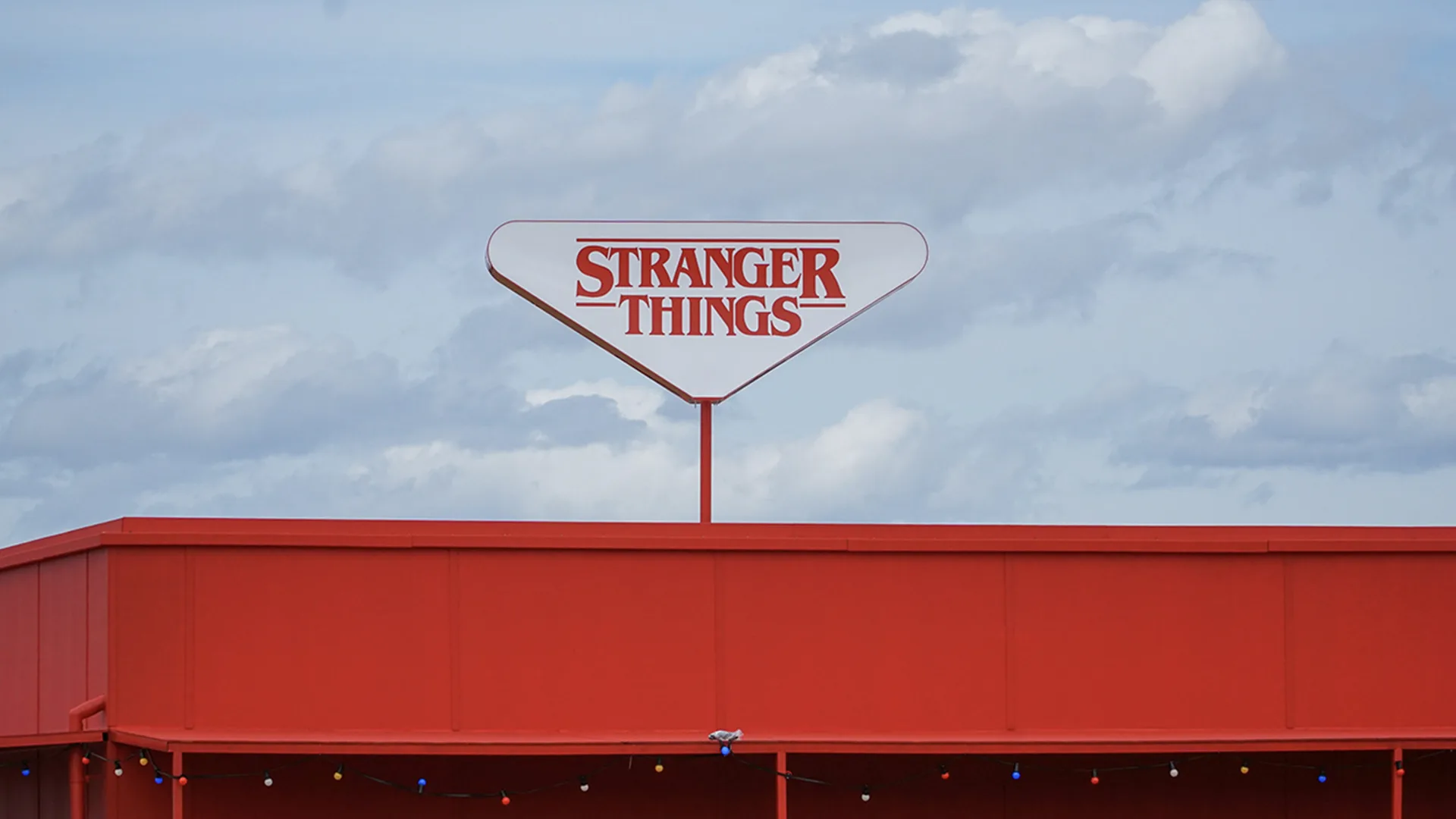 An image of the logo for Stranger Things against a background of the sky