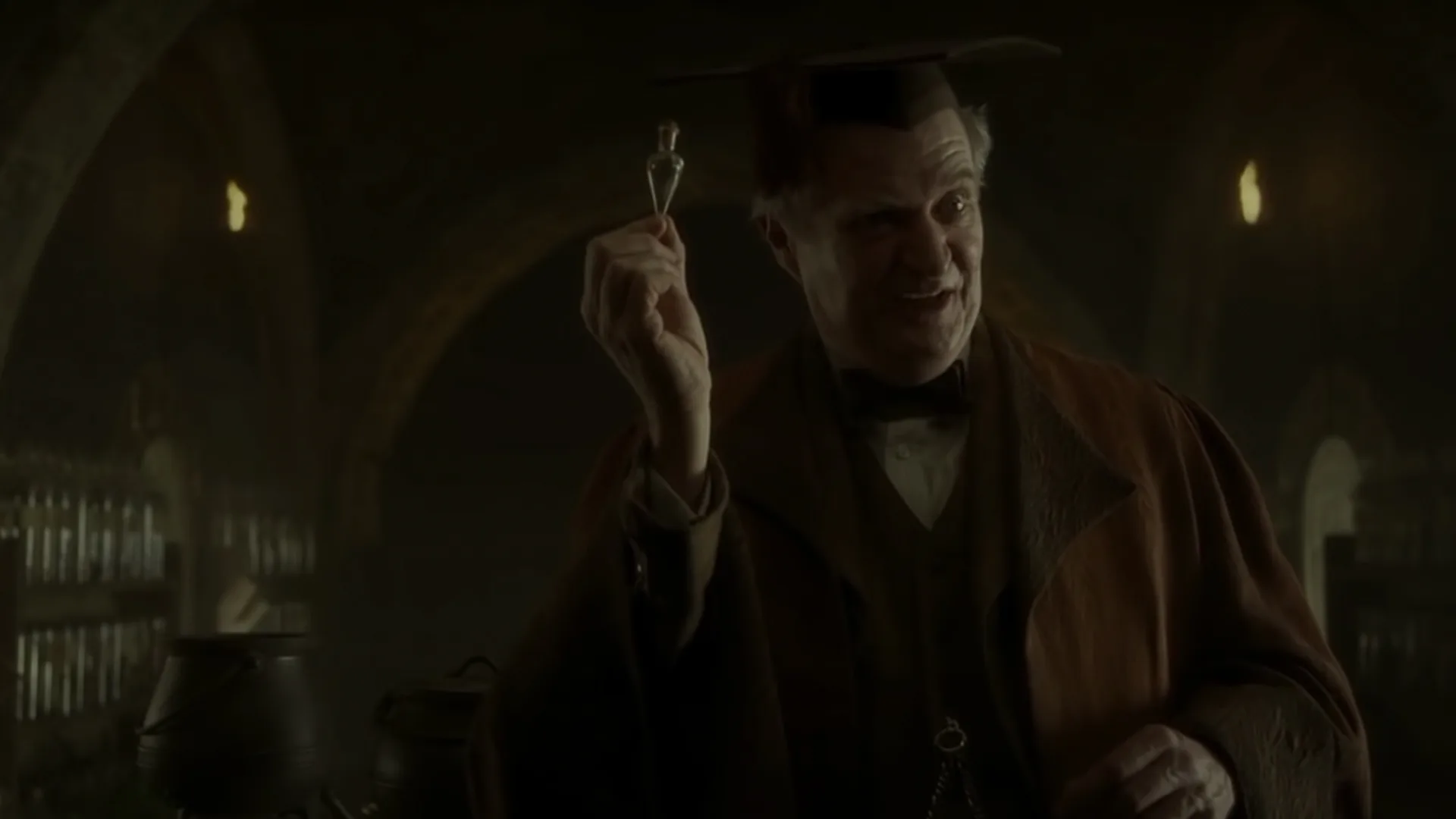 A teacher holding a potion
