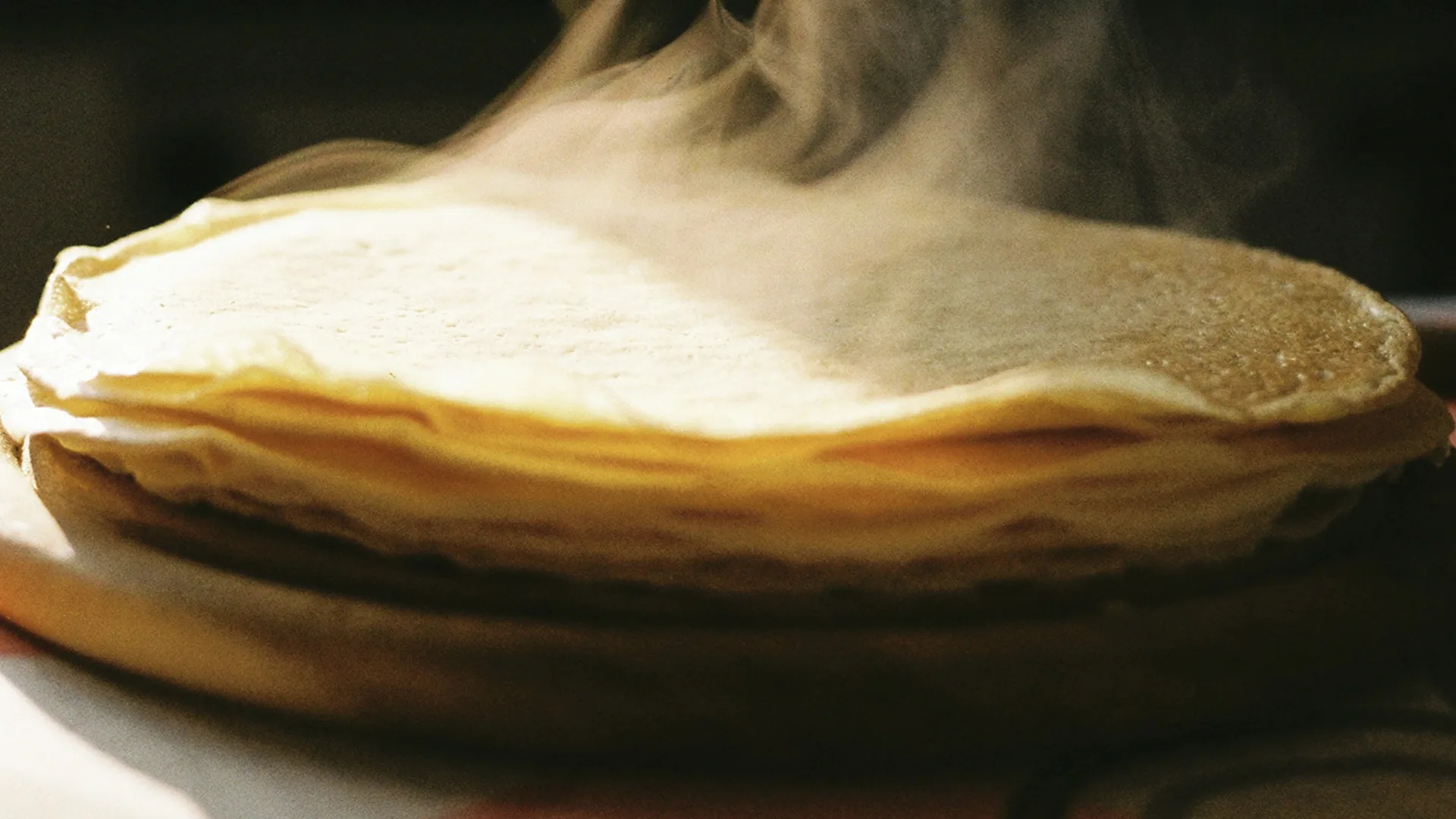 Pile of steaming pancakes