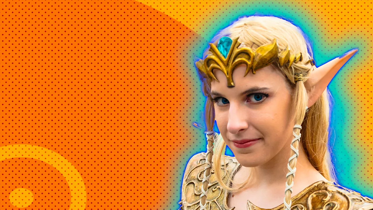 A photo of a cosplayer as the princess Zelda in a blonde wig with elvin ears against an orange dotted background with a blue halo