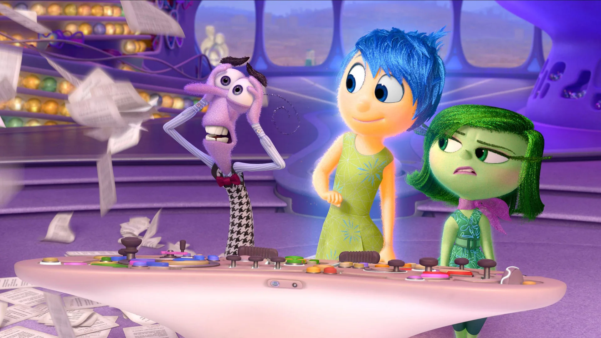 A scene from Inside Out showing Fear having a freakout as Joy and Disgust look on whilst all stood at the control panel