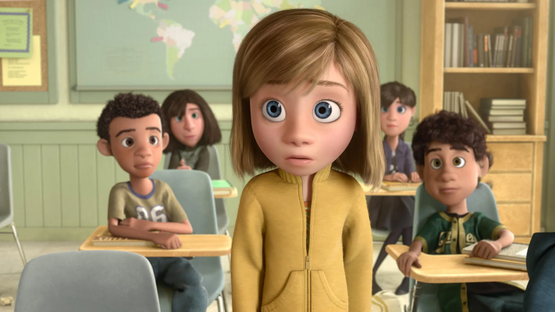 A scene from the Disney/Pixar film Inside Out showing Riley stood up in class with her classmates looking at her from behind