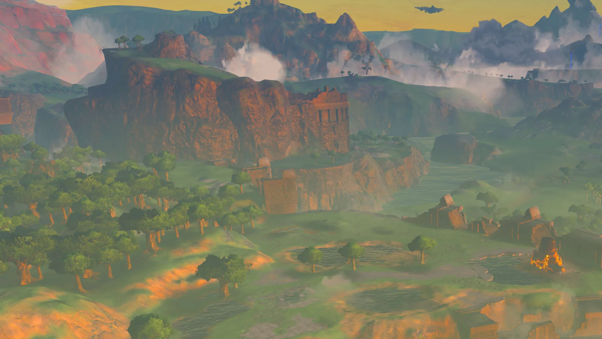 A scene from Zelda: Breath of the Wild showing a landscape at sunset with brown cliffs in the background.