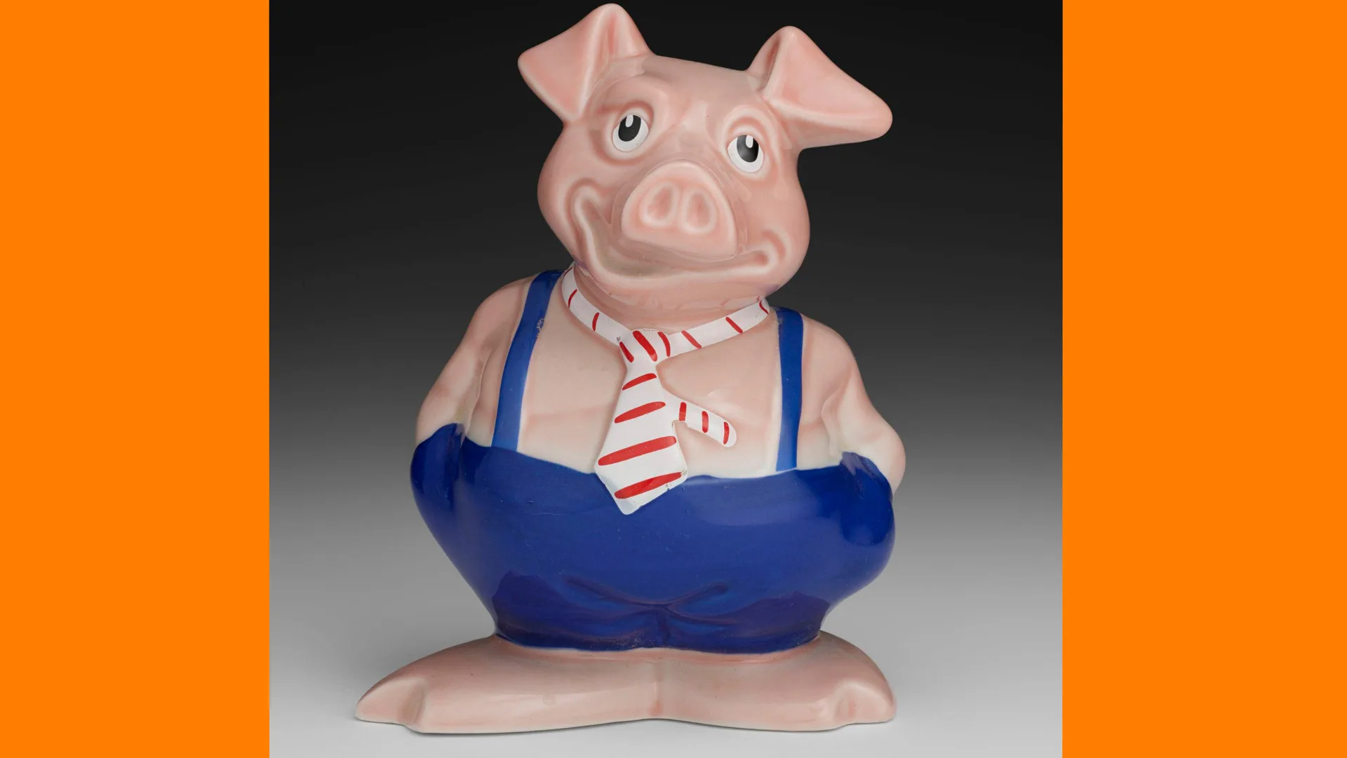 A photograph of a piggy bank, shaped like a pig called Maxwell who wears a red and white striped tie and blue dungaree trousers with bare trotters. The background is grey and black with orange borders.