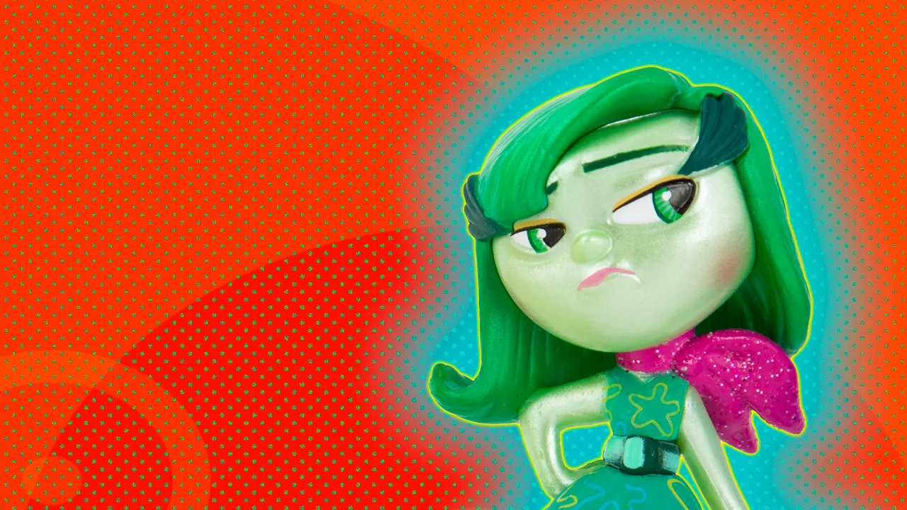 An image of a figurine toy representing Disgust from the film Inside Out set against an orange dotted background with a blue halo