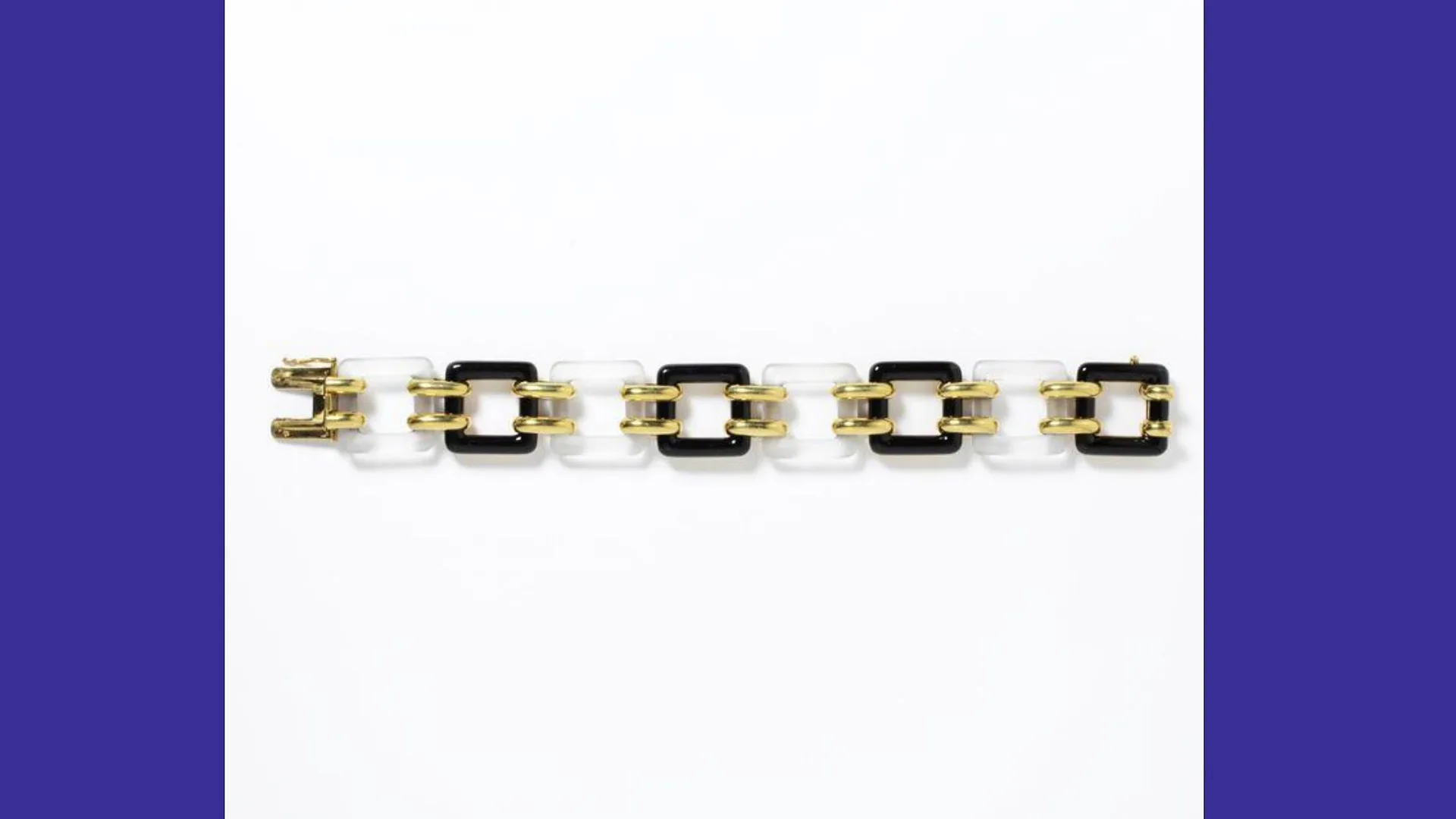 A photograph of a rockstone chainlink gold and black bracelet from the 1920s against a white background with blue borders