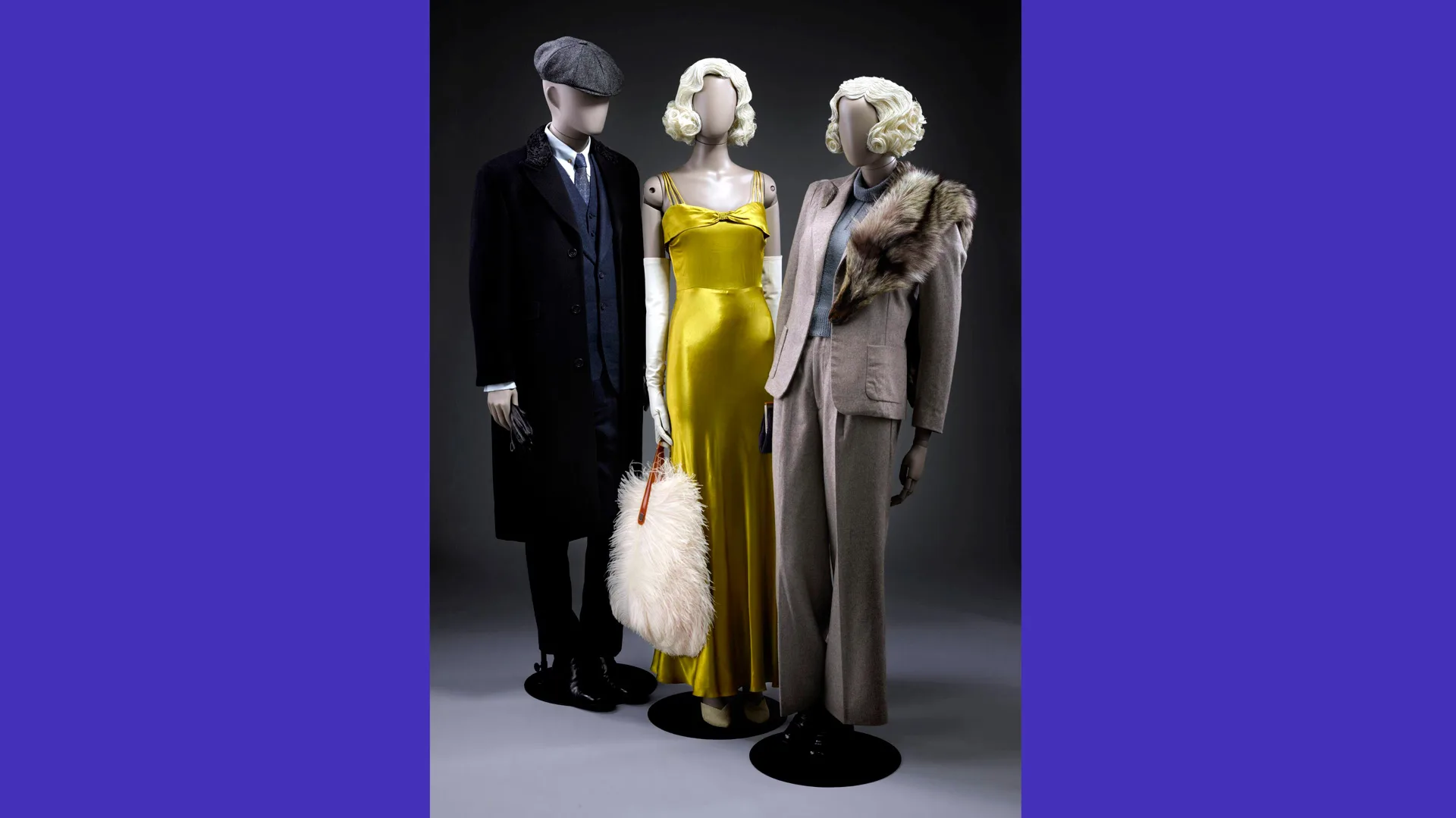 A photograph of three mannequins wearing a suit, yellow dress and a grey suit dress against a black background with blue borders