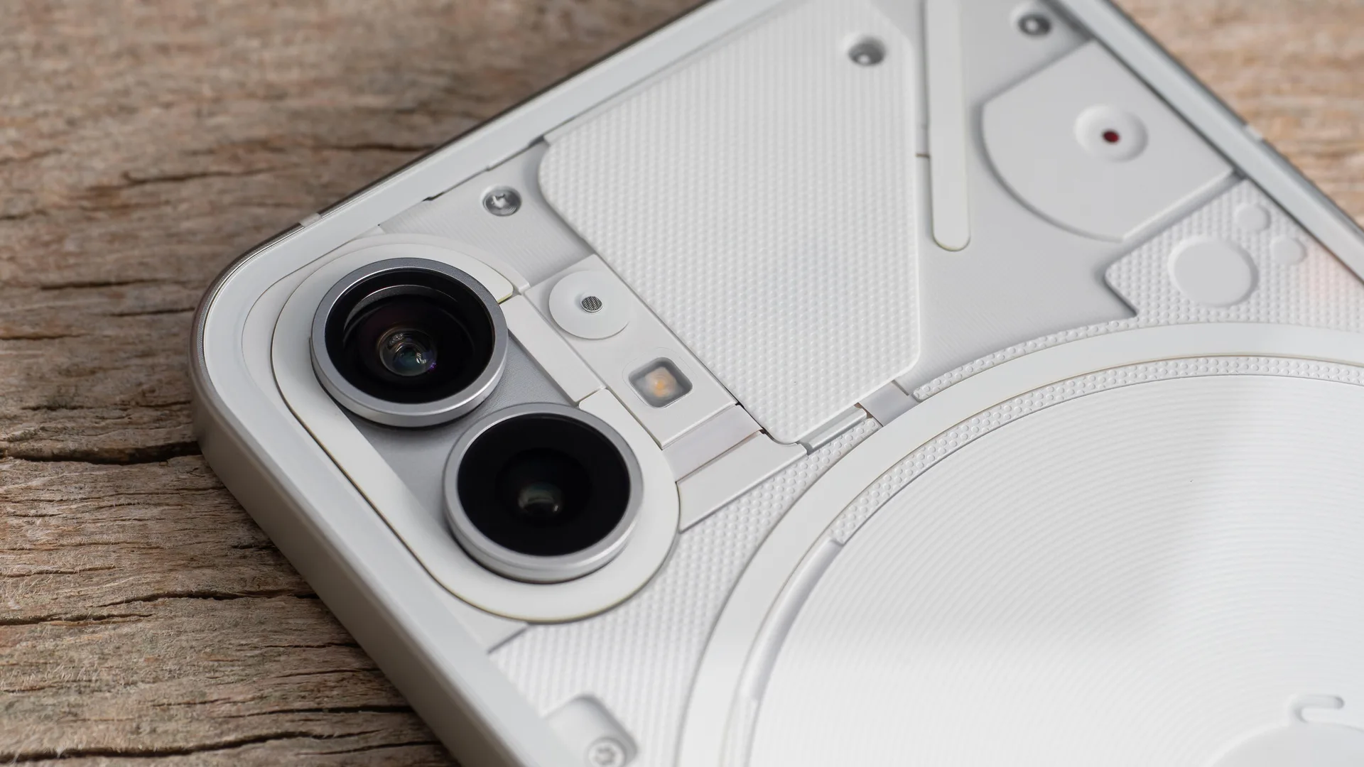 A photo of a Nothing phone up close showing it's futuristic white design with two camera lenses