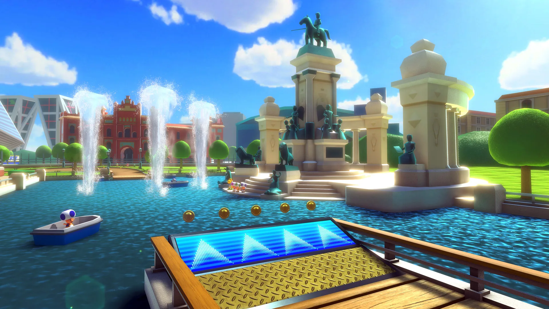 A still from Mario Kart showing a water world scene with a ramp overlooking a lake with fountains and pillars in the distance against a blue clouded sky