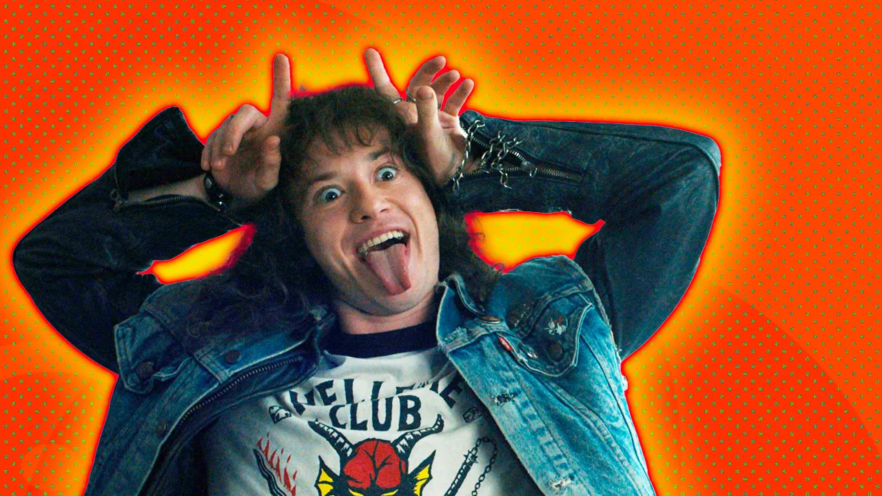 A photo of the character Eddie Munson from Stranger Things wearing his hellfire tshirt making a devil gesture against an orange background with a yellow halo