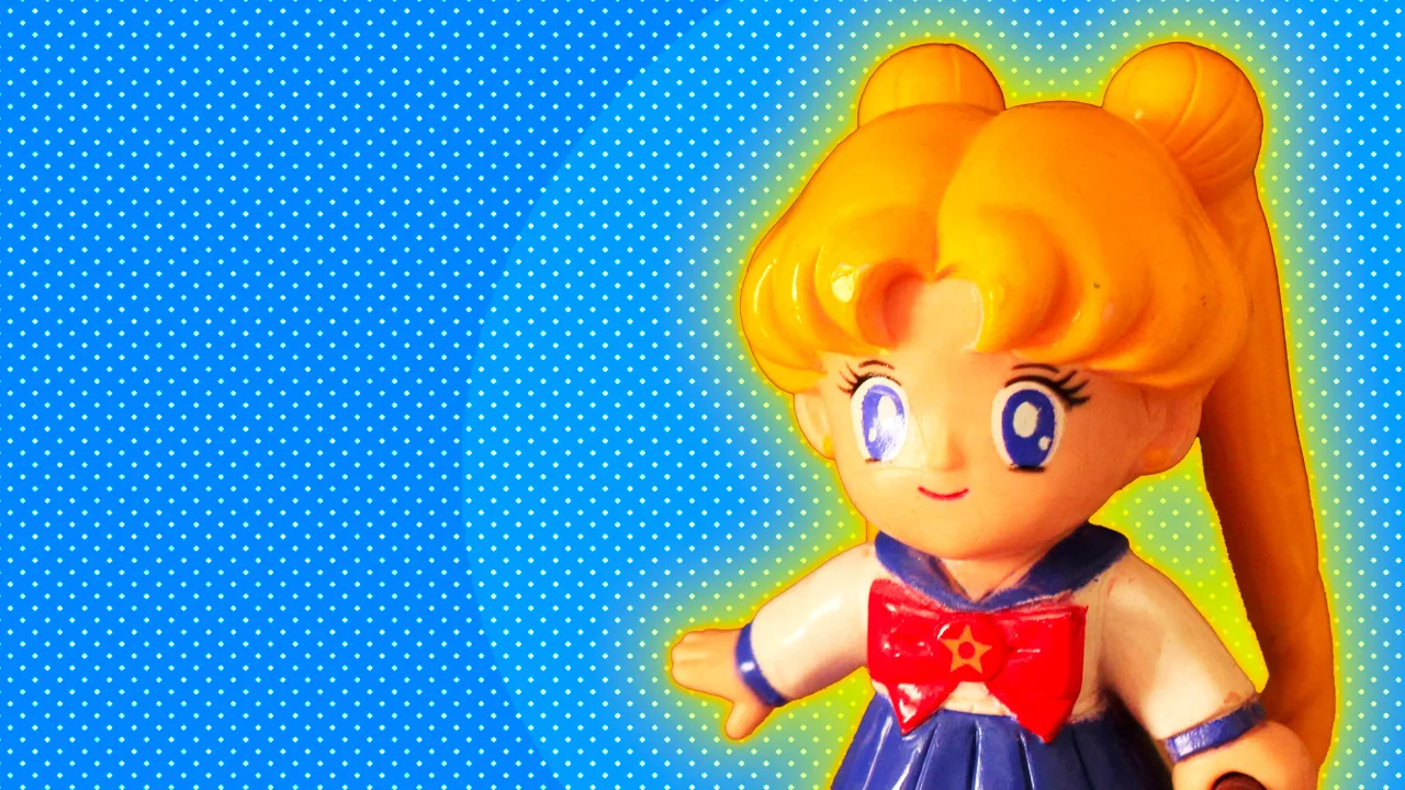 An image of a Sailor Moon doll against a blue background with yellow halo