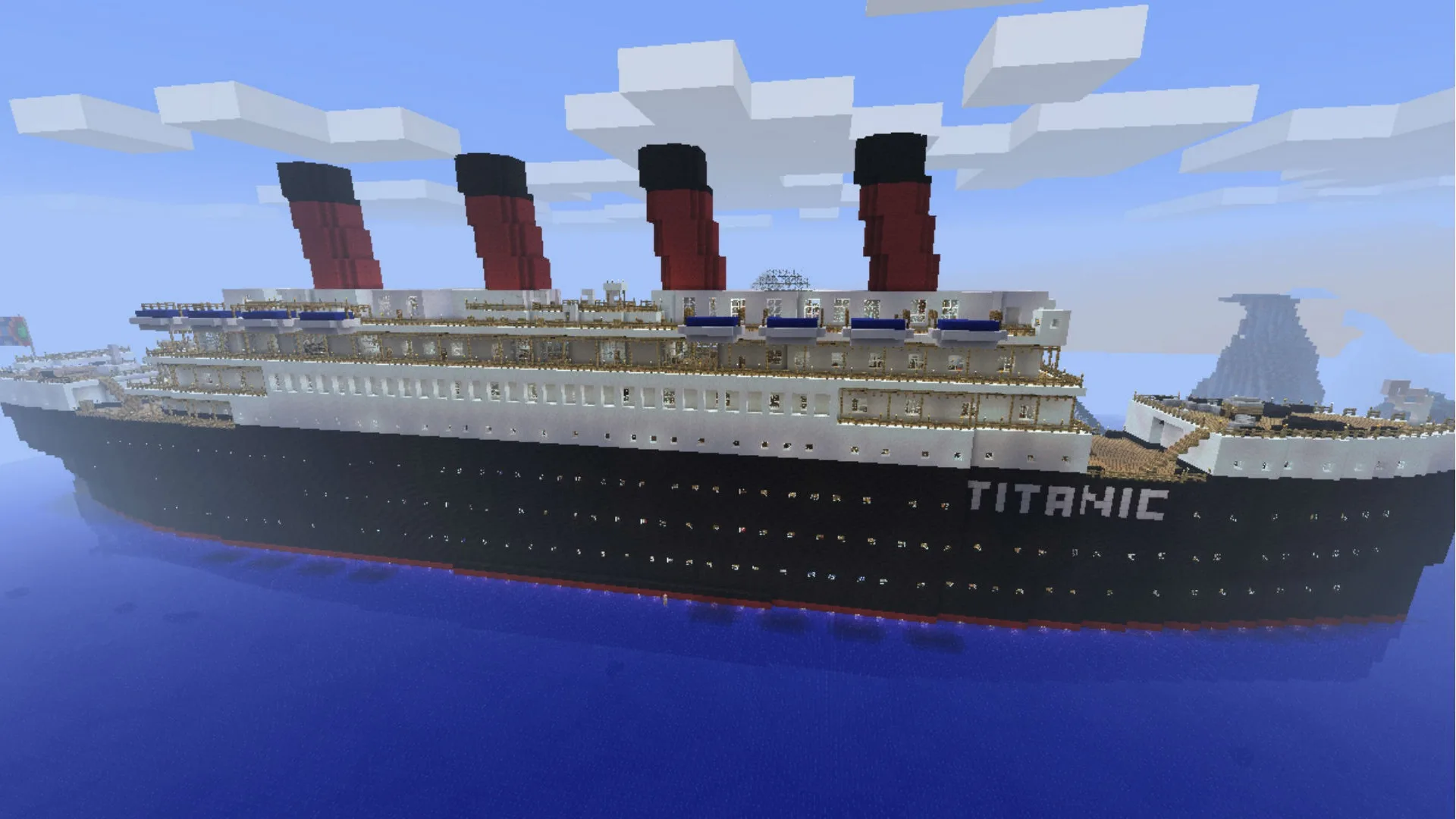 An image of a Minecraft build of the RMS Titanic sat on the ocean with a blue sky and clouds above it