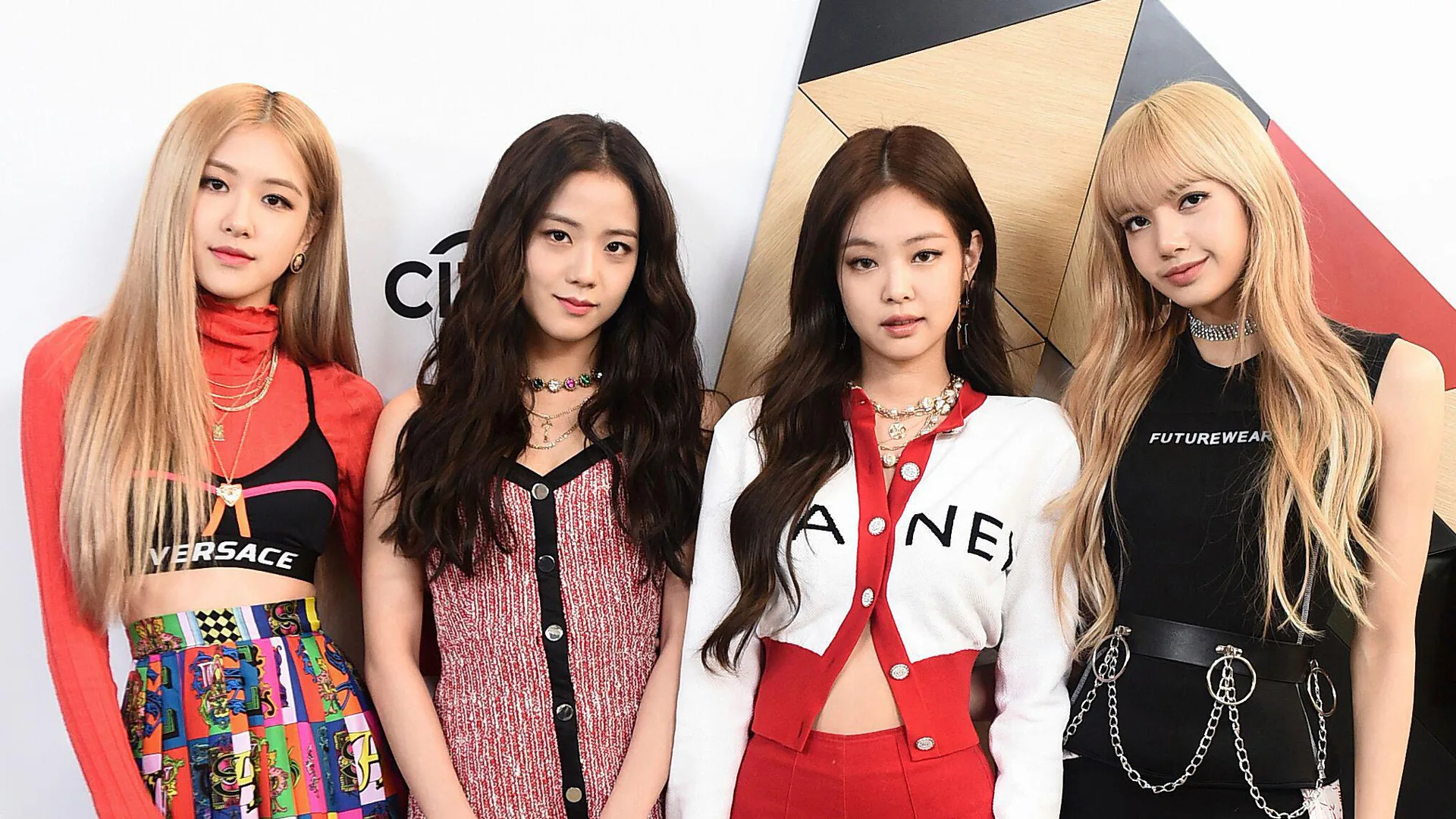 Blackpink on the red carpet wearing a combo of designer outfits including Chanel and Versace