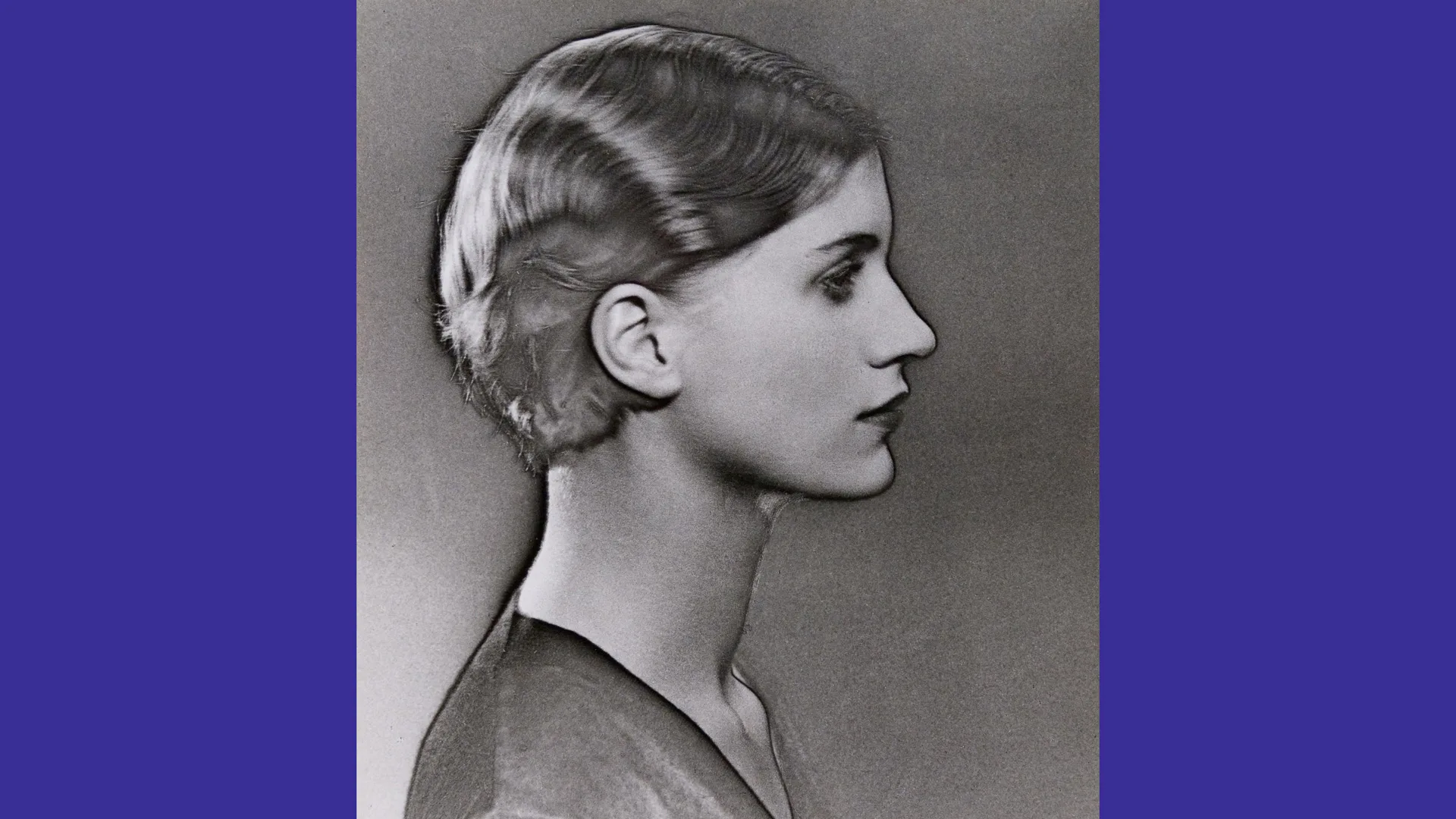 A black and white photograph of Lee Miller in side profile with the solarisation process that makes it look burned slightly and makes the subject stand out.