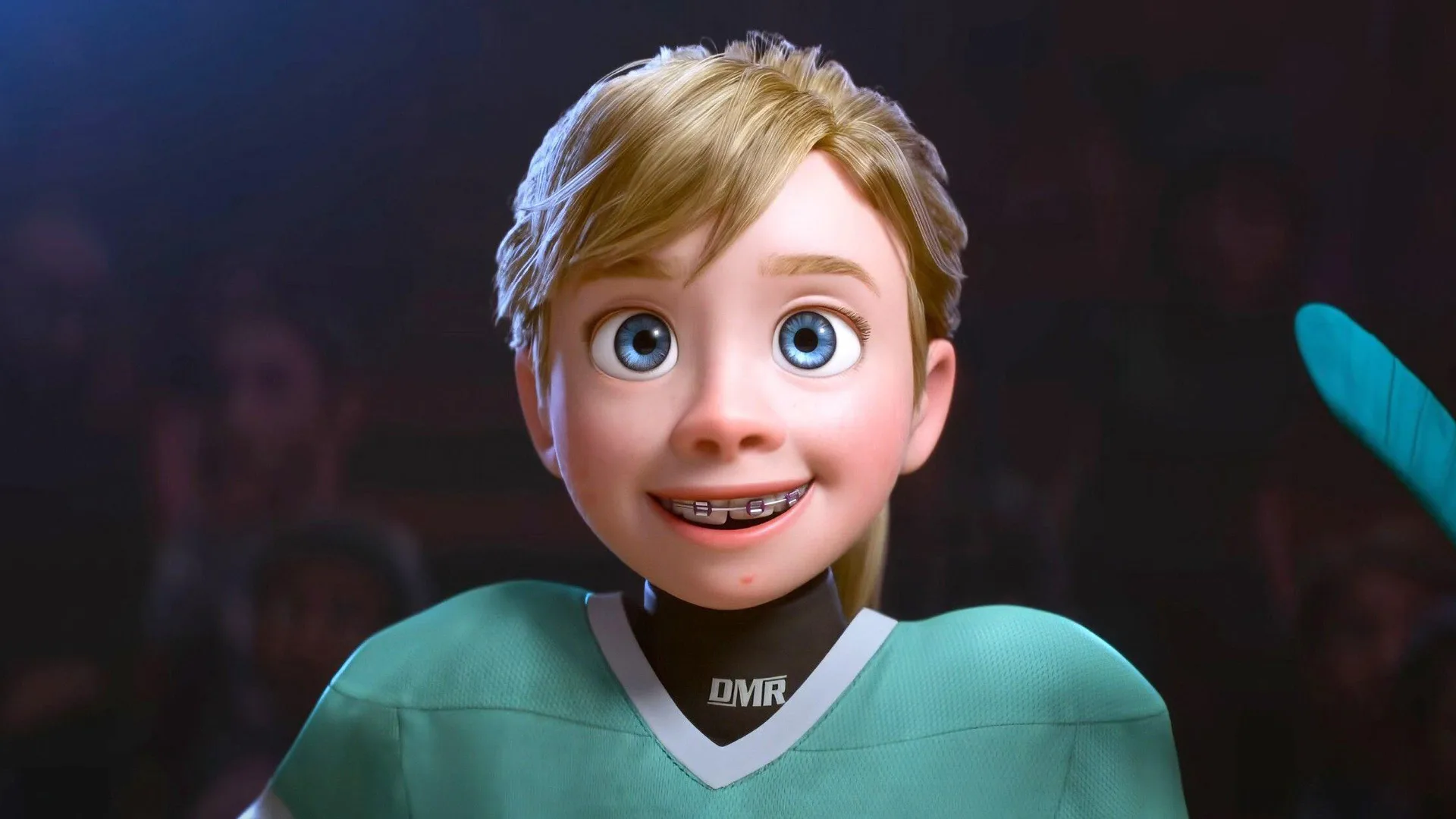 A still from Inside Out 2 showing Riley in her hockey shirt smiling against a dark blue background