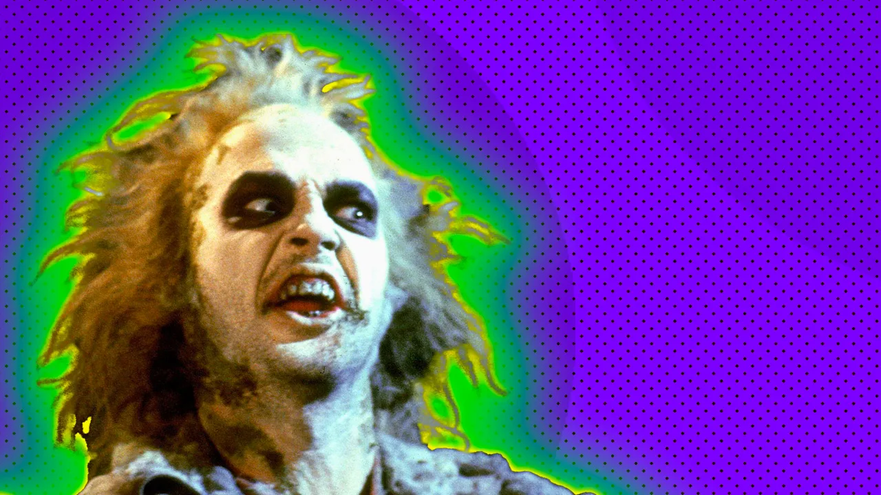 A photo of Beetlejuice making an angry face surrounded by a green halo against a purple dotted background