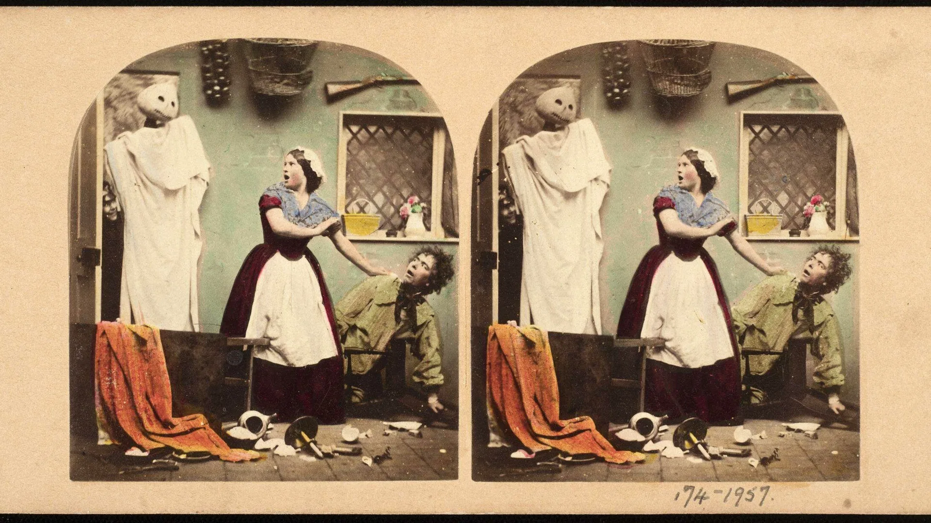 A photo of two Victorian photographs showing a woman dressed as a maid screaming at a person dressed as a ghost with a white sheet and head with holes for eyes. They are surrounded by a chaotic messy room with a broken curtain and crockery. The maid is leaning on a man on the ground who looks terrified. The photograph is colourised in blues, greens and oranges with an archway border framing both identical pictures.