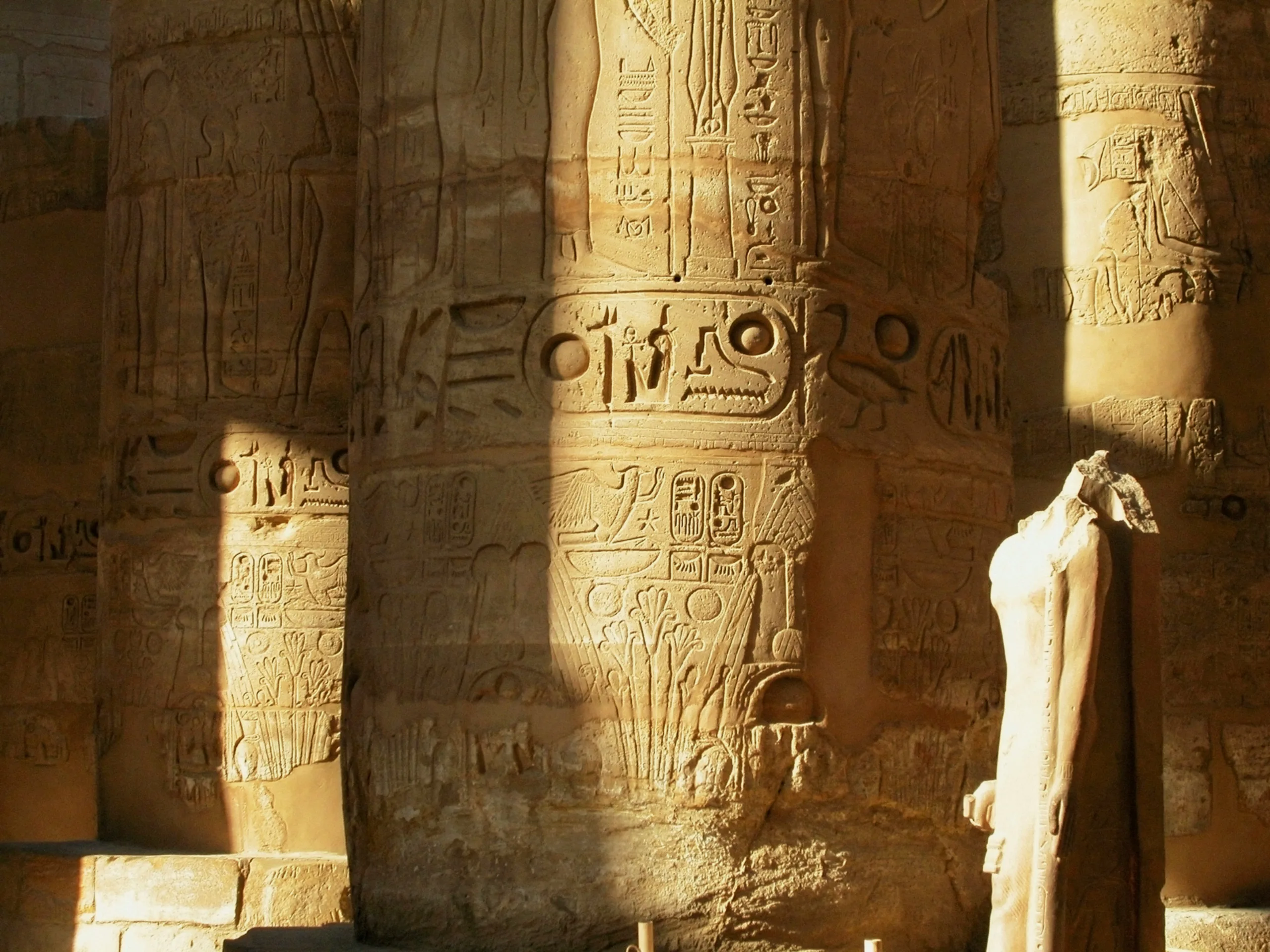 A photo of some limestone pillars from Ancient Egypt with writing carved into the stone.