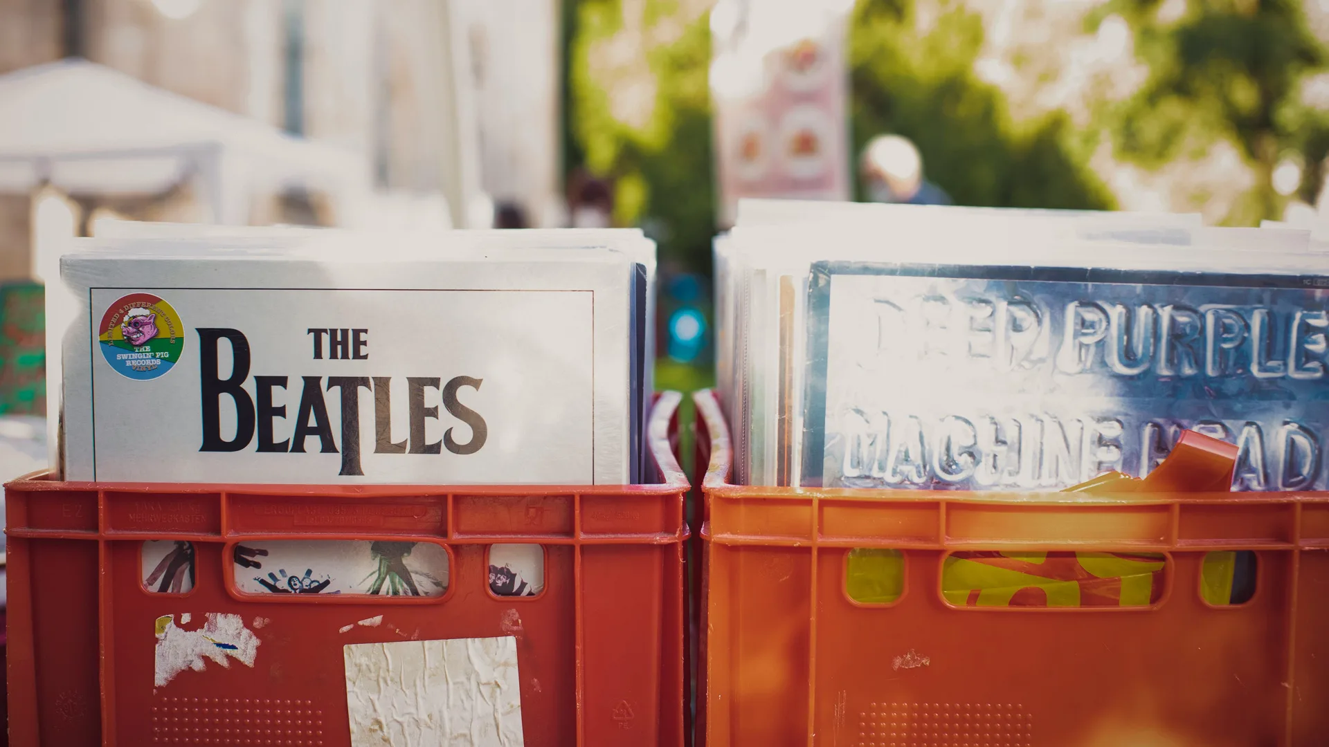 A photo of vinyl albums in red crates, including a Beatles album