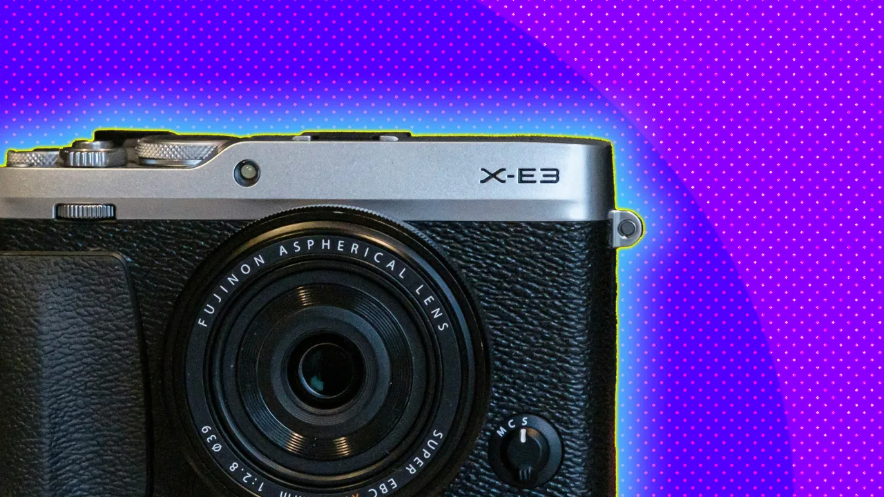 A photo of a black digital camera against a purple dotted background with a blue halo.