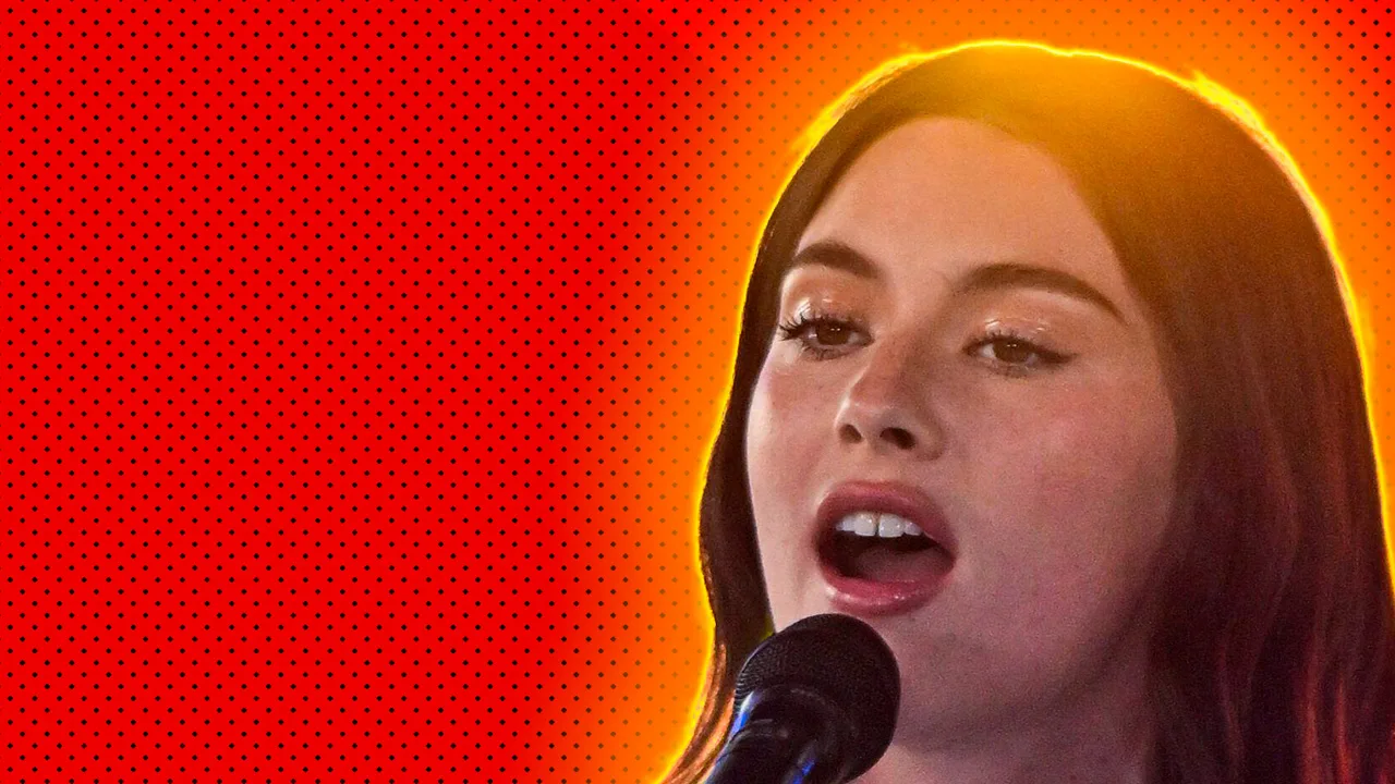 A close up of Gracie Abrams singing into a mic with a yellow halo and red dotted background