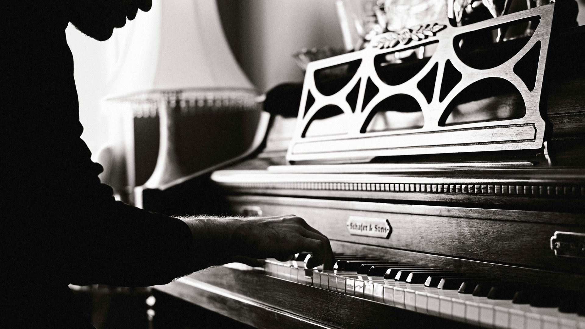 A black and white photo of a person playing the piano.