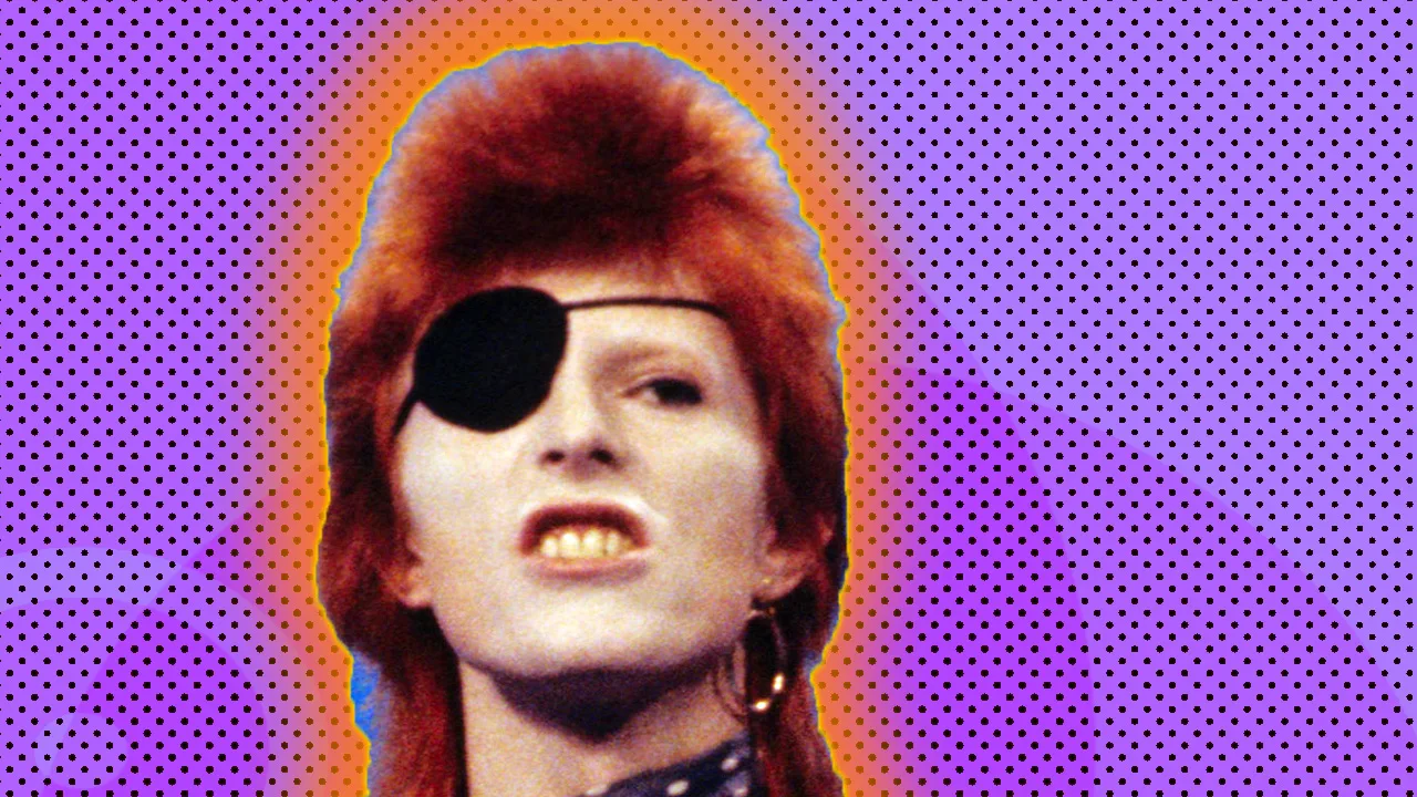 A photo of David Bowie wearing an eye patch over his face as he grimaces at the viewer with red cropped hair. He is against a purple dotted background with an orange halo.