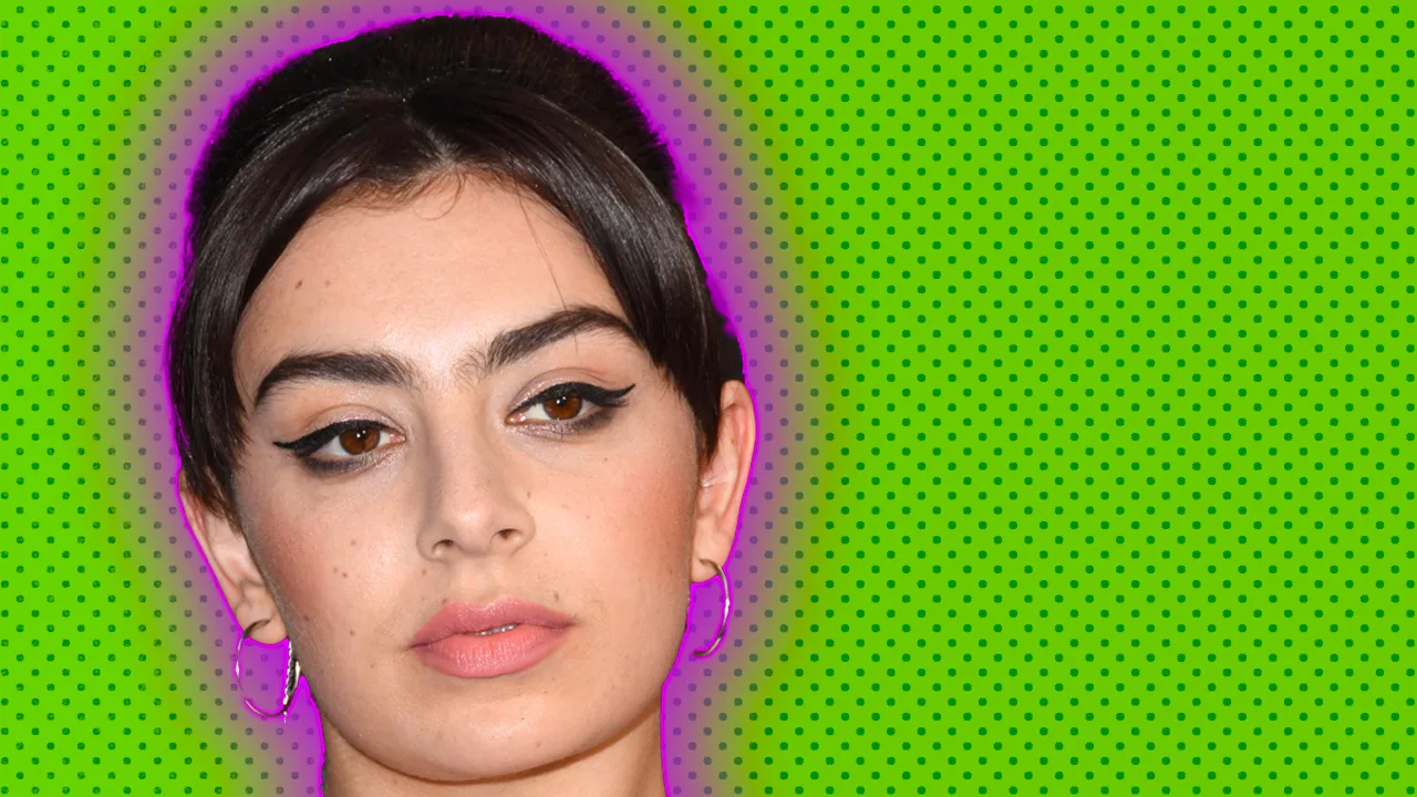 A photo of Charli XCX wearing her hair up and centre-parted against a green dotted background with pink halo.