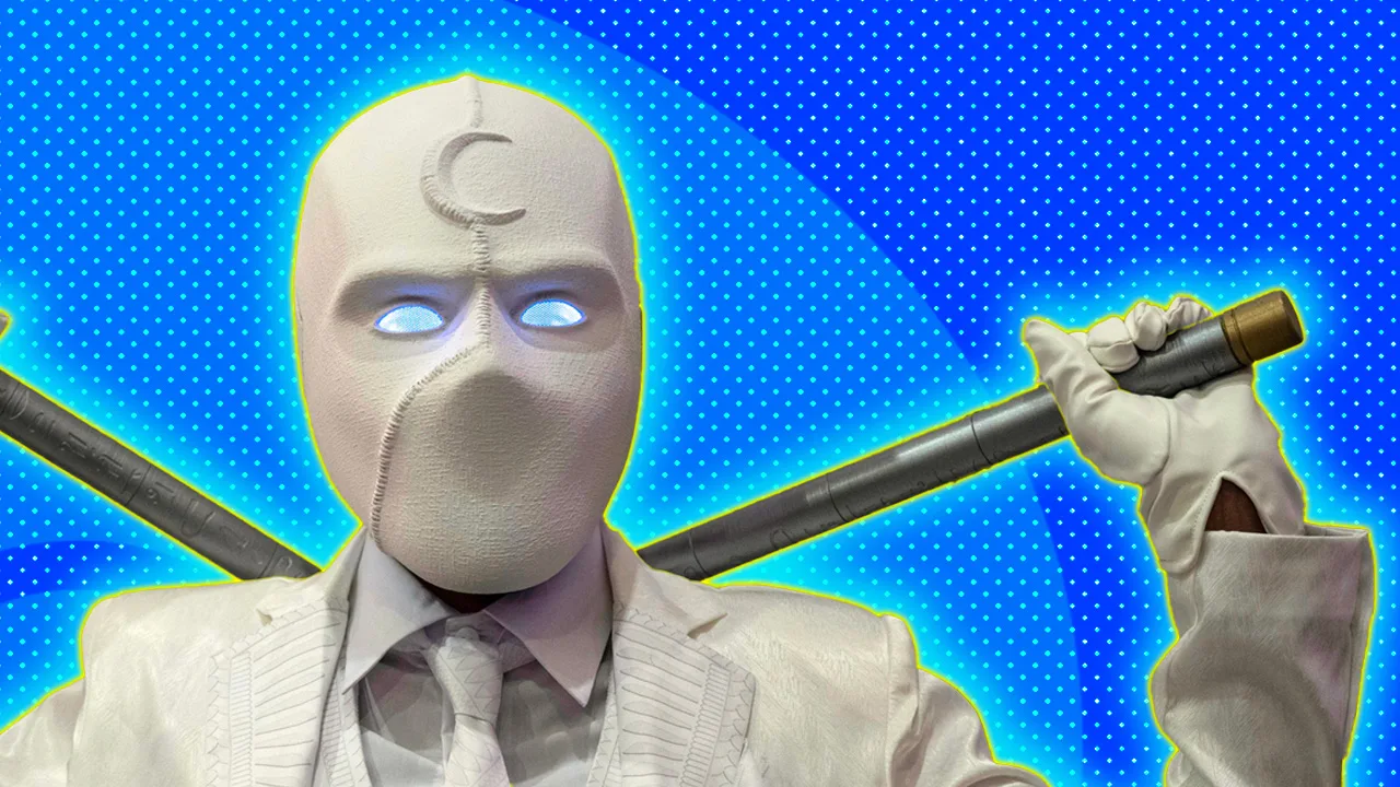 A photo of Moon Knight holding two sticks behind his shoulders wearing all white with a crescent moon on his forehead against a blue dotted background with a yellow halo.