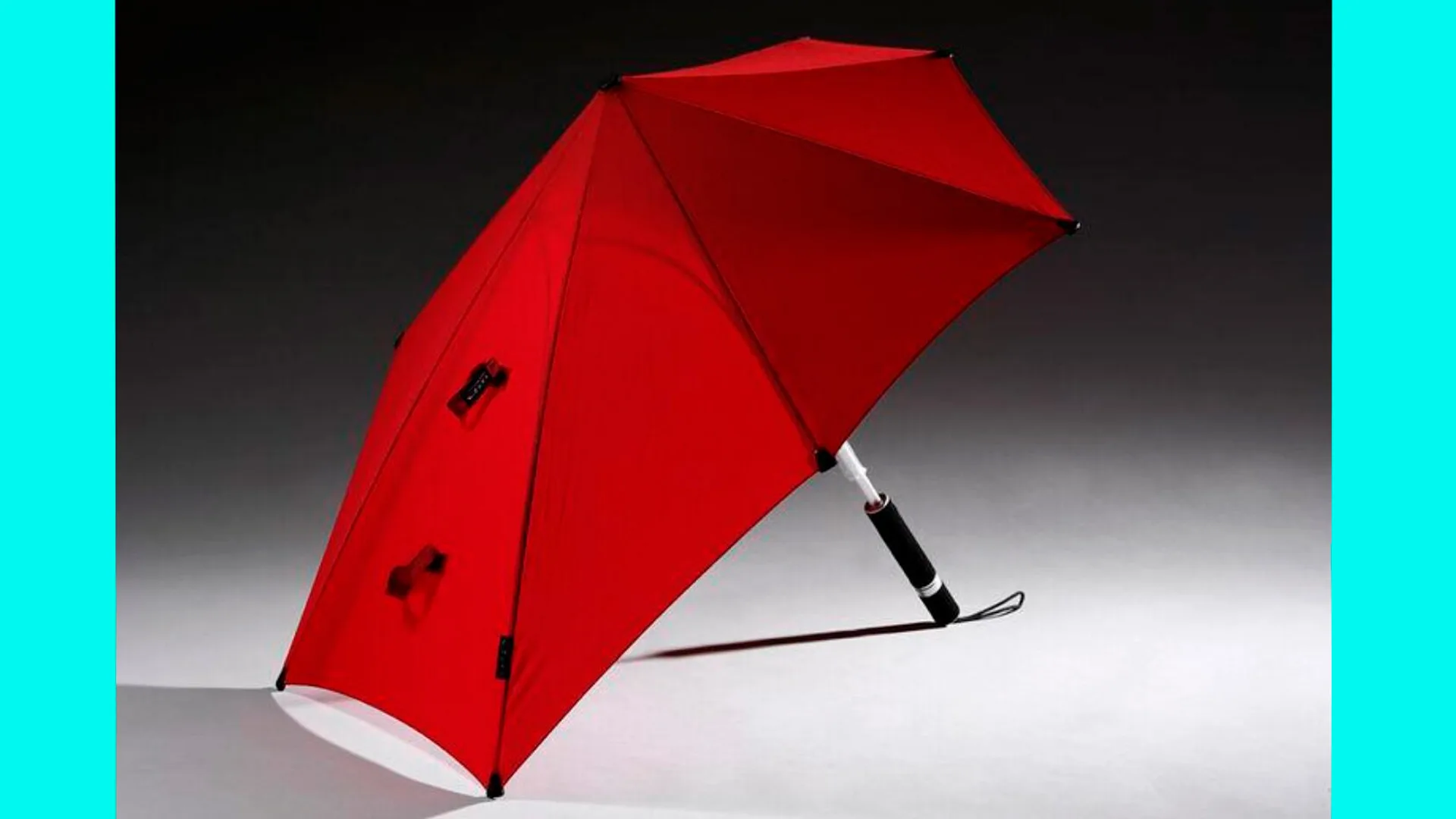 A photo of a red umbrella fully open and on it's side on a grey and black background with bright blue borders